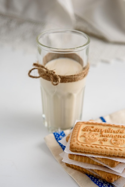 Zdjęcie mleko w szklance i ciasteczka na stole