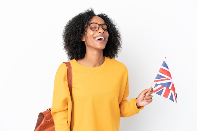 Młoda Afroamerykanka Trzymająca Flagę Wielkiej Brytanii Na Białym Tle Ze śmiechu