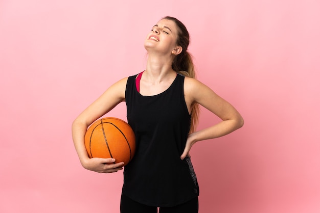 Młoda Blond Kobieta Gra W Koszykówkę Na Białym Tle Na Różowej Przestrzeni Cierpi Na Bóle Pleców Za Wysiłek