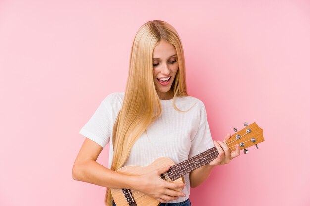 Młoda blondynki kobieta bawić się ukelele