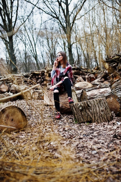 Młoda dziewczyna palenia papierosów w lesie