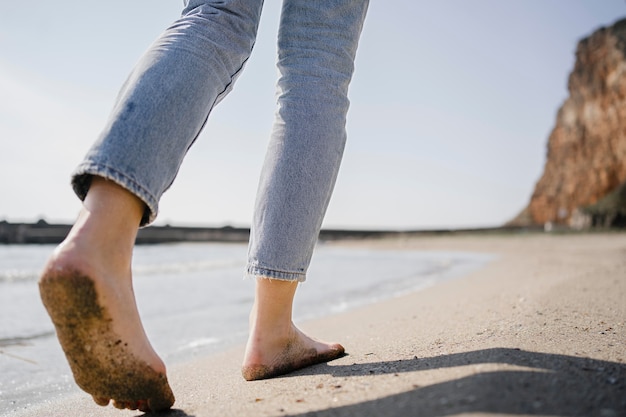 Zdjęcie młoda kobieta spaceru na piasku na plaży