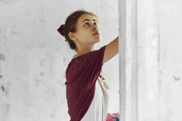 Zdjęcie młoda kobieta stojąca przy ścianie.