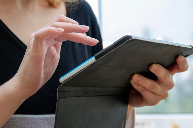 Młoda kobieta używa tabletu w domu