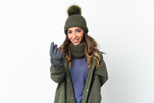 Młoda kobieta z kapeluszem zima odizolowywającym robi pieniądze gestowi