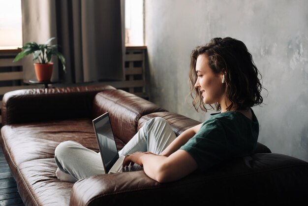 Młoda kobieta zaangażowana w pracę zdalną lub naukę przedstawiająca styl życia studenta lub freelancera wi