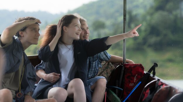 Zdjęcie młoda para siedzi na łodzi w drodze do lasu nad tamą na trekking