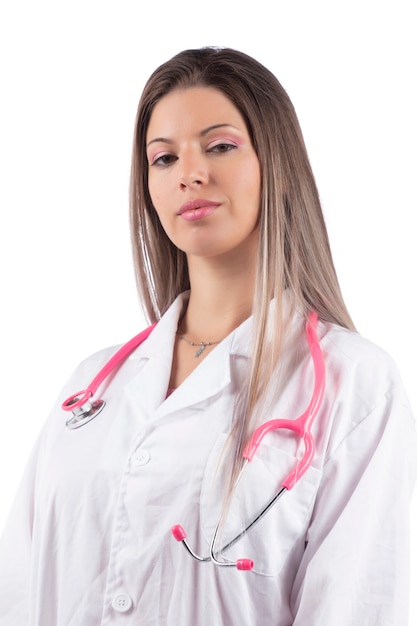 Młoda piękna kobieta lekarz z różowym stetoskopem.