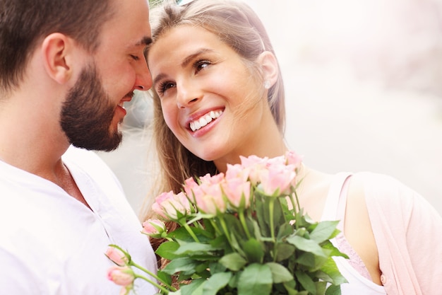 młoda romantyczna para z kwiatami w mieście