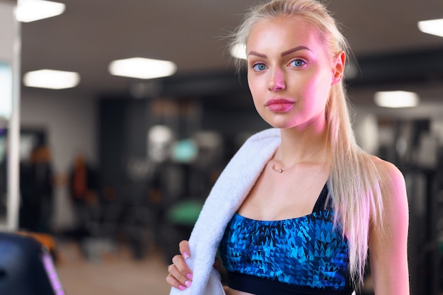 Młoda sportowa kobieta ćwiczy w gym. Trening cardio na bieżni.