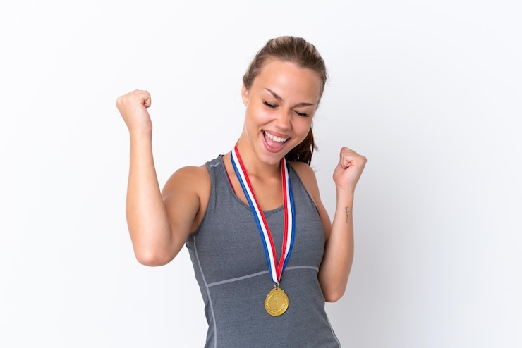 Zdjęcie młoda sportowa rosyjska dziewczyna z medalami na białym tle świętuje zwycięstwo