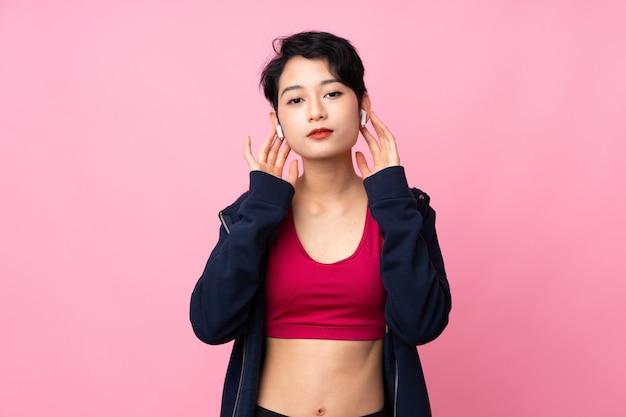 Młodego Sporta Azjatycka Kobieta Słucha Muzykę I Patrzeje Do Przodu