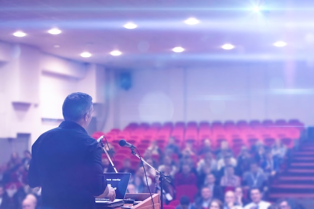 Młody biznesmen w sali konferencyjnej z publicznymi prezentacjami Publiczność w sali konferencyjnej Klub przedsiębiorczości