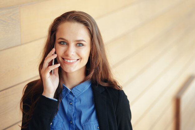 Młody bizneswoman opowiada na telefonie komórkowym