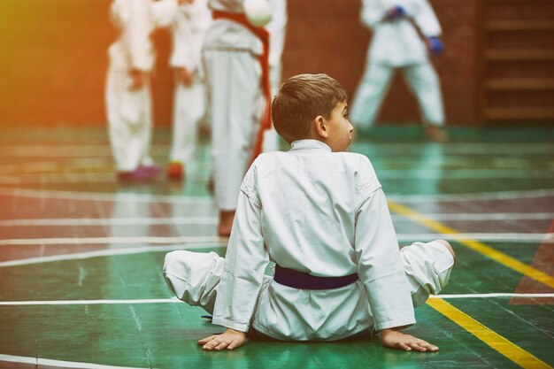 Młody chłopak karate rozgrzewka w kimono