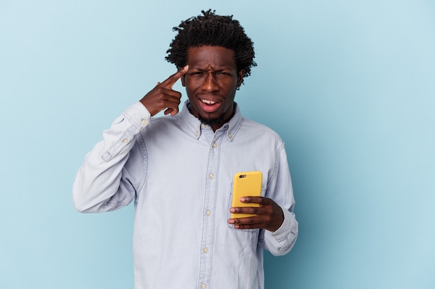 Młody Człowiek African American Posiadania Telefonu Komórkowego Na Białym Tle Na Niebieskim Tle Pokazując Gest Rozczarowania Palcem Wskazującym.