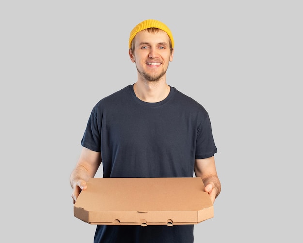 Młody człowiek z pudełkiem po pizzy w rękach dostawa pizzy