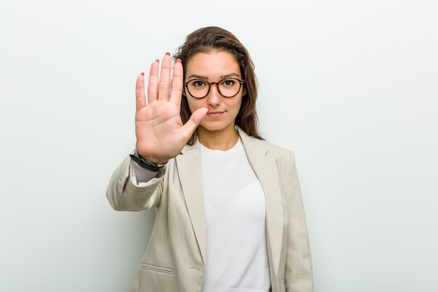 Młody Europejski Biznes Kobieta Stoi Z Wyciągniętą Ręką Pokazuje Znak Stopu, Uniemożliwiając Ci.
