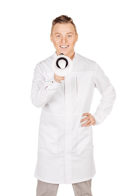 Młody mężczyzna lekarz w białym fartuchu mówiący do megafonu Koncepcja ludzie i medycyna Obraz na białym tle
