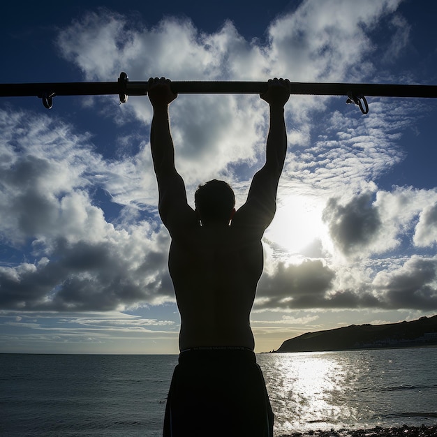 Młody mięśniowy mężczyzna wykonuje ćwiczenia na ulicy na poziomym pasku ćwiczenia dla bicepsów i tricepsów na tle zachodu słońca
