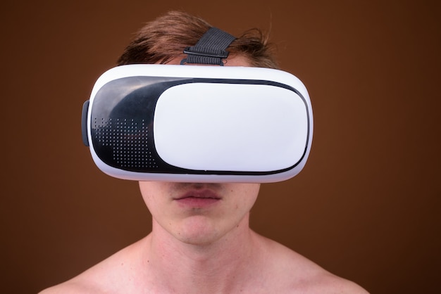młody przystojny mężczyzna za pomocą okularów wirtualnej rzeczywistości bez koszuli
