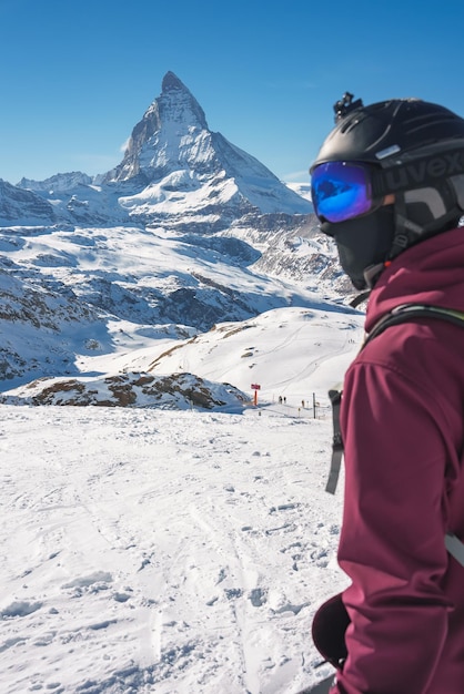 Młody snowboardzista spędza ferie zimowe w Zermatt w pobliżu słynnego szczytu Matterhorn