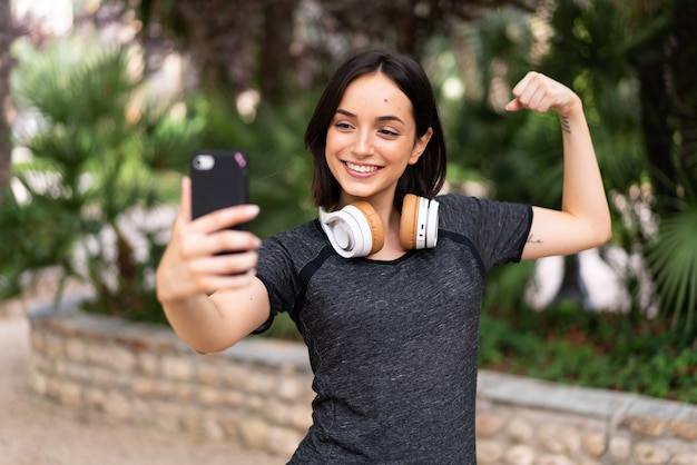 Młody sport kaukaski kobieta robi selfie na świeżym powietrzu w parku