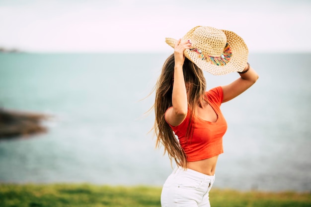 Zdjęcie młodzi ludzie w samotnej zabawie na świeżym powietrzu młoda kobieta, ciesząc się i świętując samotnie na zewnątrz z widokiem na ocean koncepcja wakacji i turystów w miejscu docelowym po podróży
