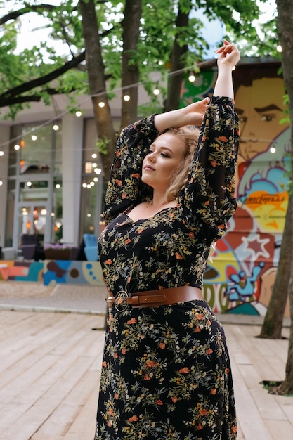 Zdjęcie modelka plus size blondynka w modnej sukience retro kręcone blondynki w parku miasto spacer portret baner reklama