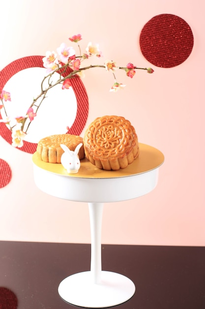 Mooncake Na Jasnoróżowym Tle Z Różowym Kwiatem. Koncepcja Moon Cake Na święto środka Jesieni. Mooncake Popularny Jako Kue Bulan.