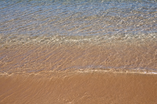 Morze tło natura tropikalnej letniej plaży z promieniami światła słonecznego Piaskowa plaża morska woda z kopią