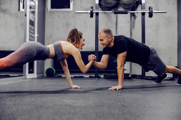 Motywacja i wsparcie w treningu sportowego stylu życia Para wspólnie wykonuje ćwiczenia sportowe