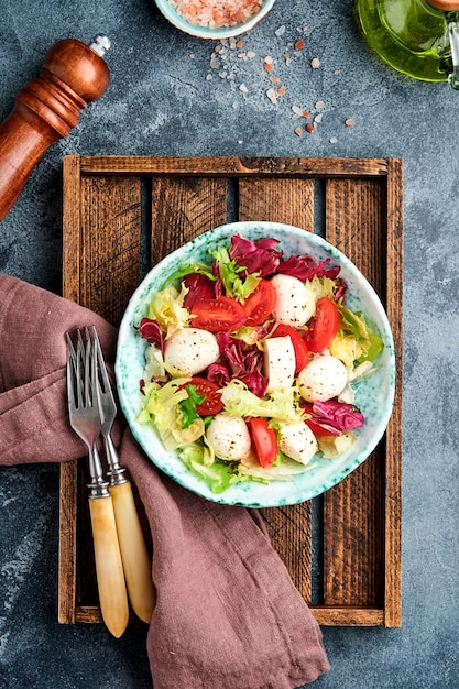 Mozzarella, Pomidor I Mieszanka świeżych Liści Sałat, Ciemna Powierzchnia, Widok Z Góry.