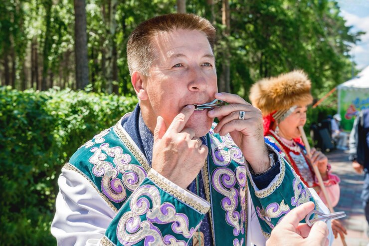 Zdjęcie muzyk gra na instrumencie muzycznym komus harp, instrumencie muzycznym ludów północy