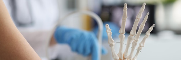 Zdjęcie na stole lekarza jest zamazany plastikowy szkielet palców