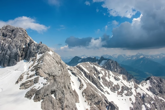 Na szczycie Dachstein i widok na alpejskie góry. Park Narodowy w Austrii, Europie. Błękitne i pochmurne niebo w letni dzień