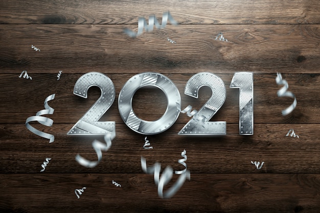 Zdjęcie napis na nowy rok 2021 z metalowymi numerami na podłoże drewniane.