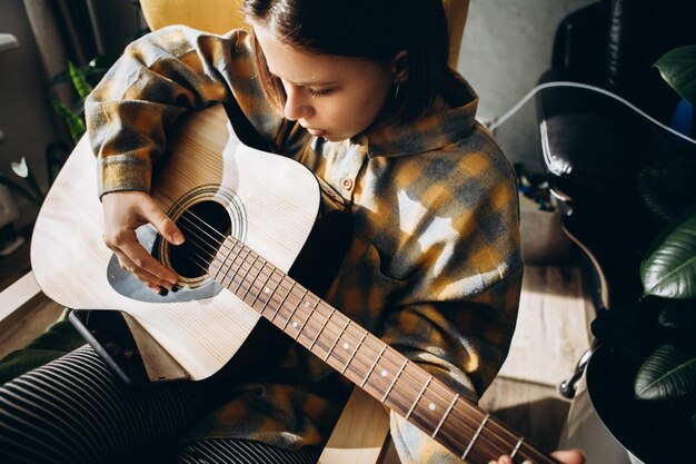 Nastolatka ucząca się grać na gitarze