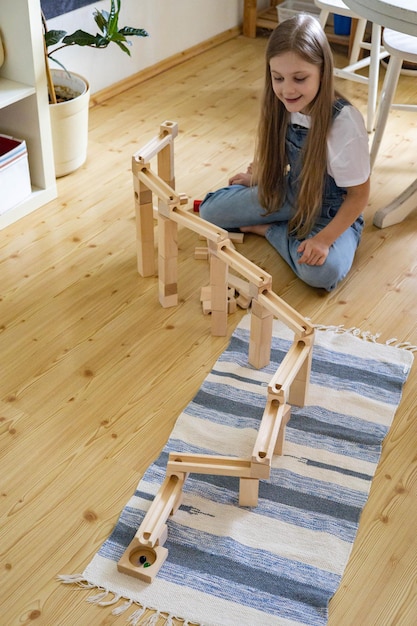 Nastoletnia Dziewczyna Grająca W Konstruktora Toru Blokowego Z Metalową Kulką Maria Montessori Materiałów