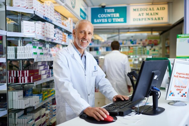 Nasz System Pozwala Nam Szybko Zlokalizować Potrzebne Leki Portret Dojrzałego Farmaceuty Pracującego Przy Komputerze W Aptece