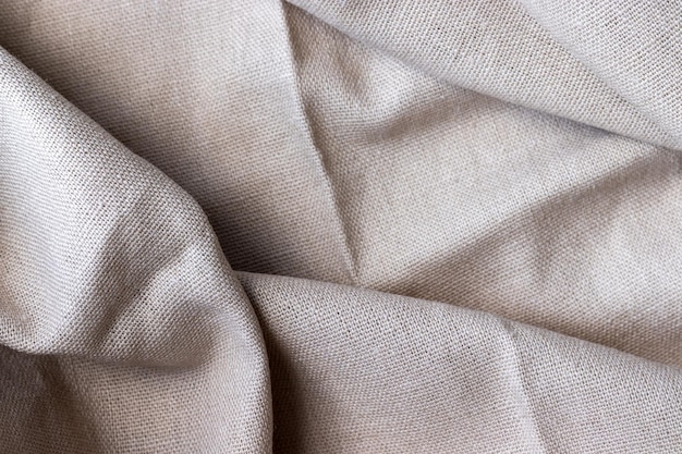 Zdjęcie naturalna beżowa tkanina lniana tekstura szorstkie zmięte juta tło selektywne focus zbliżenie widok