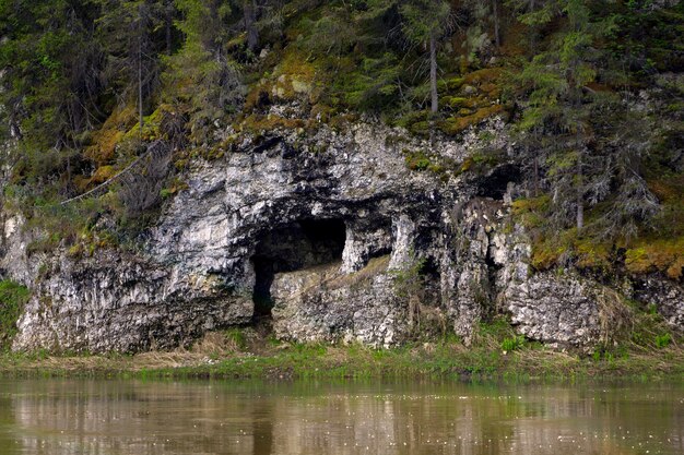 Naturalna jaskinia w wapiennym klifie na brzegu rzeki