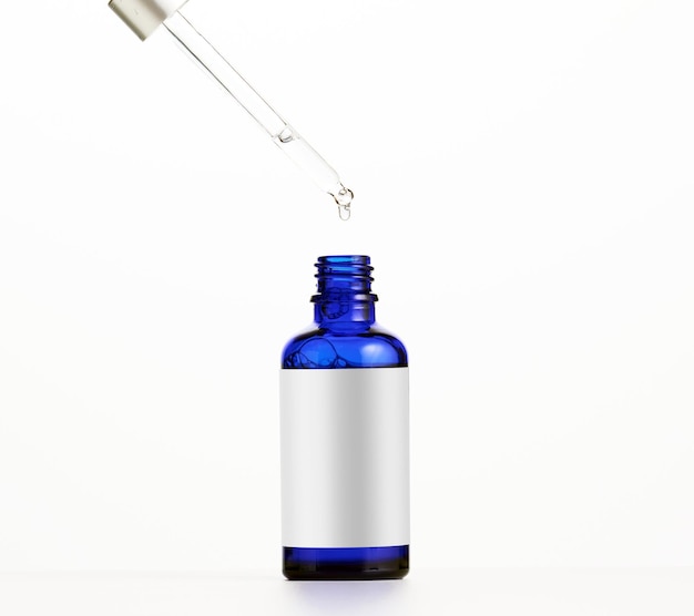 Niebieska szklana butelka z pipetą na olejki kosmetyczne i serum Reklama i promocja produktów