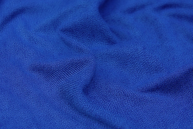 Niebieska tkanina tekstura tło, falista tkanina miękki niebieski kolor, luksusowa satyna lub jedwabna tkanina tekstura.