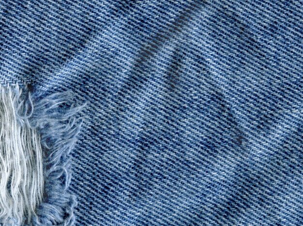 Niebieski denim dżinsowy tekstury tła Dżinsy podarte tekstury tkaniny