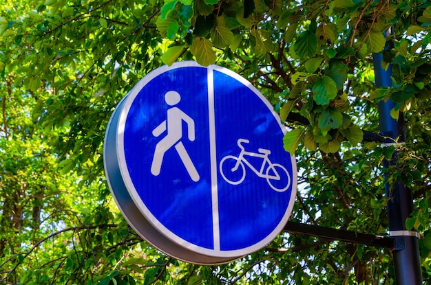 Niebiesko-biały znak z napisem „spacer” i rower.