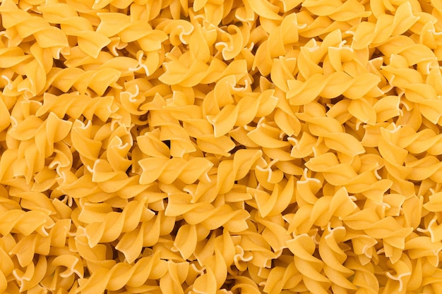 Niegotowany makaron fusilli tekstura tło