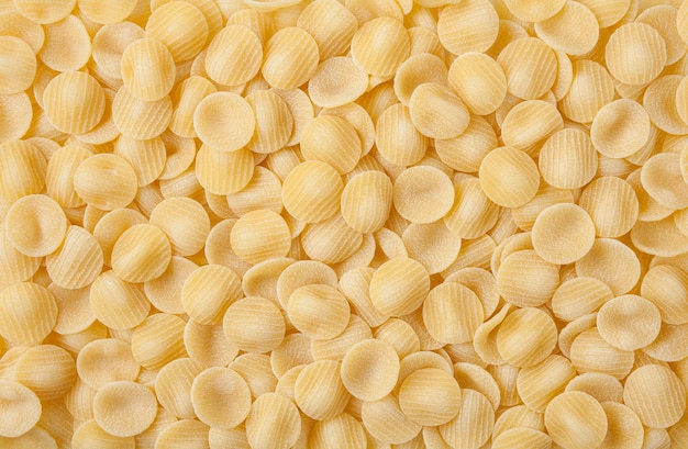 Niegotowany makaron orecchiette w tle