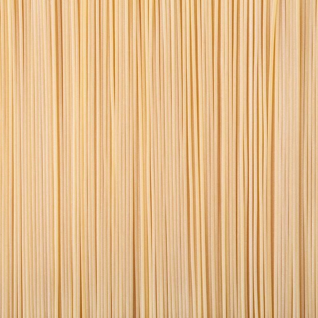 Niegotowany suszony makaron spaghetti w tle