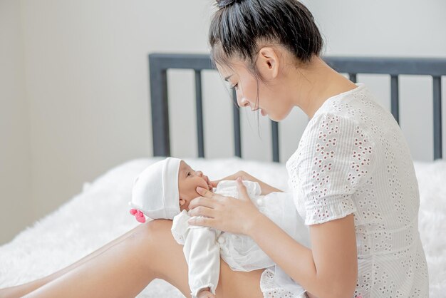 Niemowlę śpi na mamie lapasyjka mama nosi i dotyka z czułością swoje dziecko